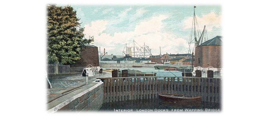 A vintage postcard showing a view of London Docks from Wapping with boats