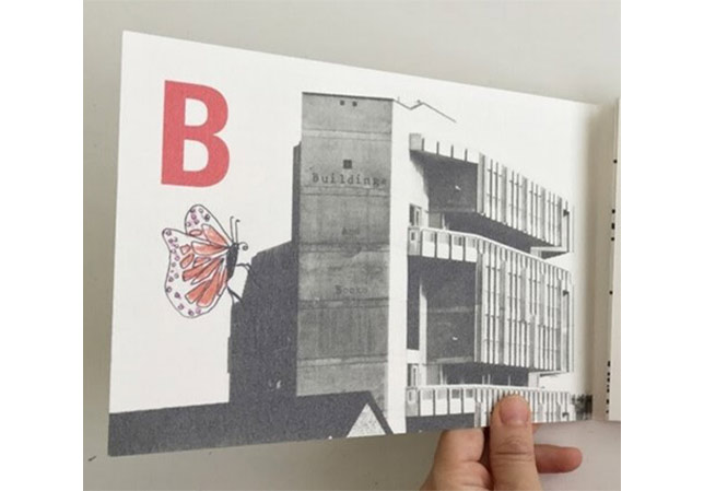 A hand holding a card with the letter B and an image of Robin Hood Gardens Estate