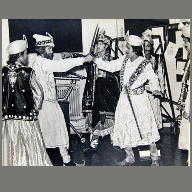 A group of Asian men performing in traditional clothing Theatre of Narratives image © Rafique Ullah