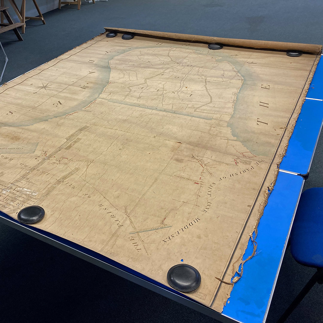 The 1812 Plan of the Isle of Dogs map on a table