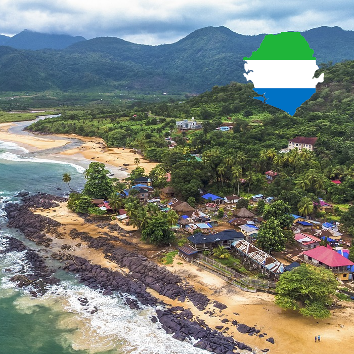 Coastal landscape of Sierra Leone with flag imposed on map in the corner.