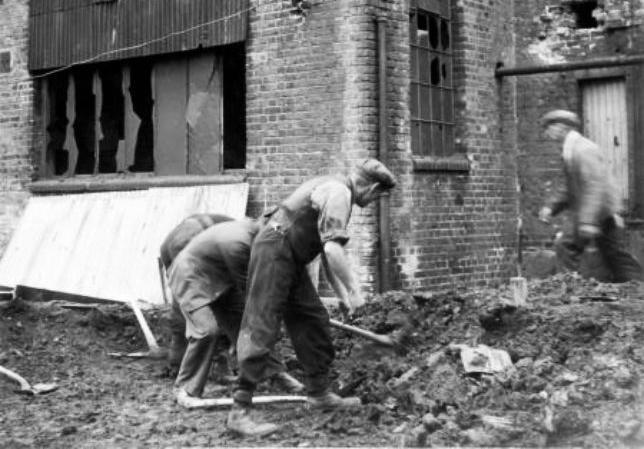 Clearing debris of bomb damage at Matthew T.Shaw’s Engineering works