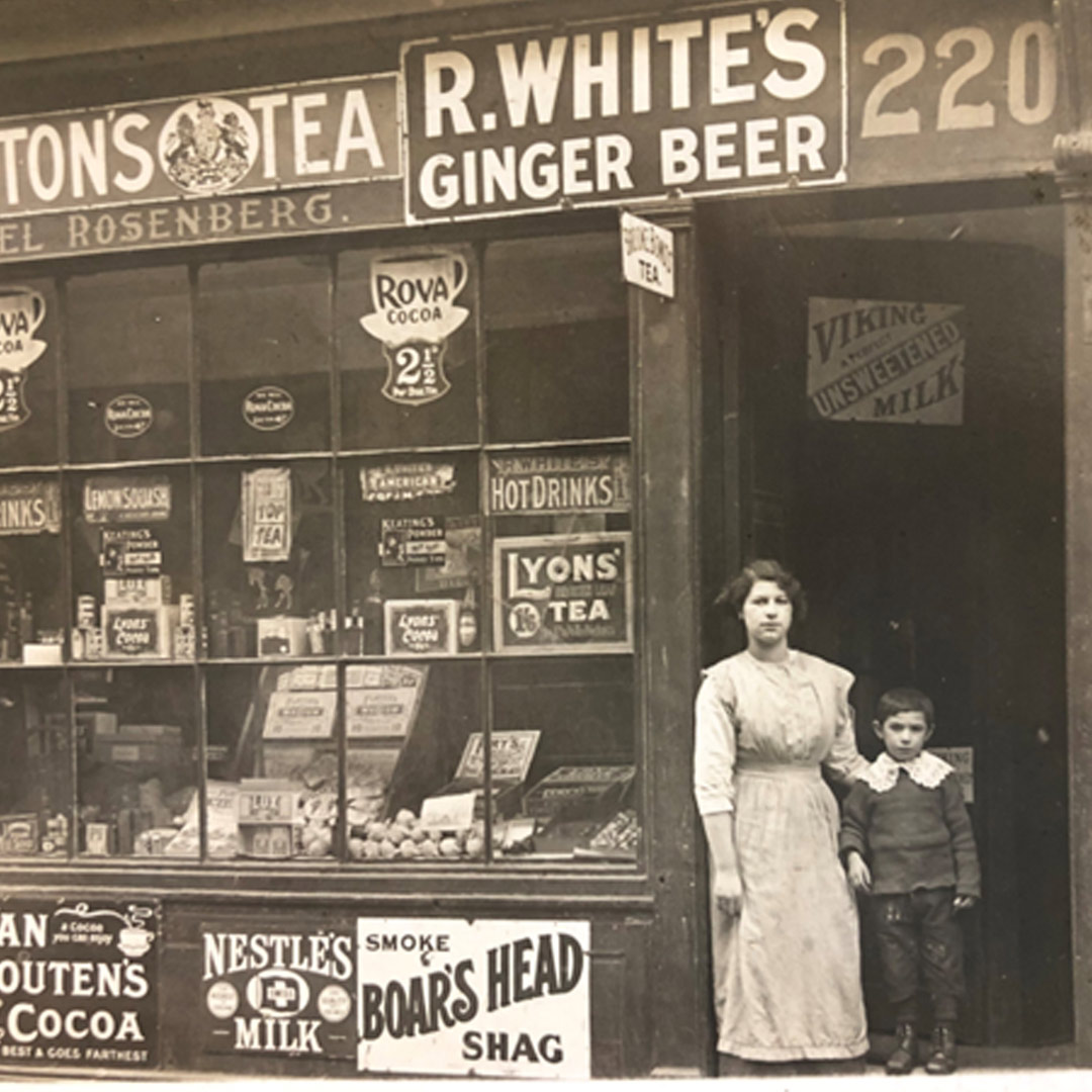 [P20969] Black and white photo of 220 St George St. (grocery store), showing two of the Rosenberg children standing outside