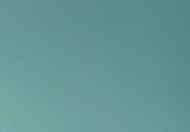 Artist Tom Lyddon holding one of his paintings